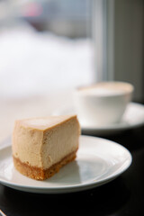 Classical caramel color New York Style Cheesecake And Coffee On Table. Side View