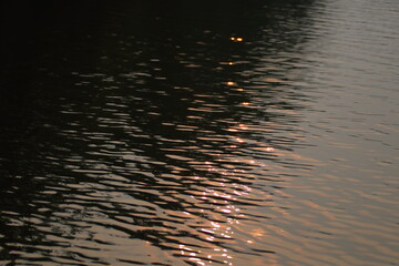 sunset reflection in water creates an abstract pattern