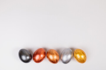 Multi-colored eggs on a uniform white background with place for text.