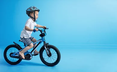Foto op Canvas Picture of little boy riding a bike - riding lesson © konradbak