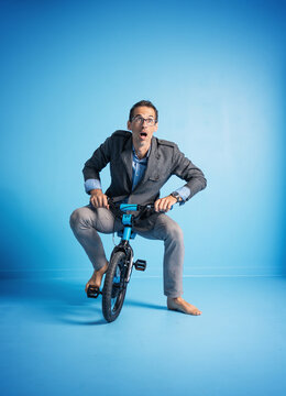 Portrait Of A Father Riding A Too Small Bike