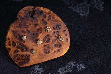 Beautiful piercing jewelry on wooden display. Macro shot. Selective focus.
