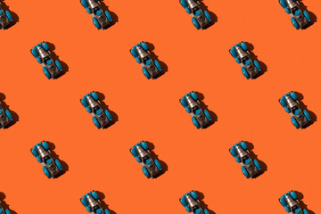 Toy retro car convertible in seamless pattern on orange background. 