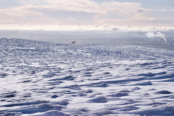 Obraz premium snow covered hill with a chimney smoke rising from the Forth Valley