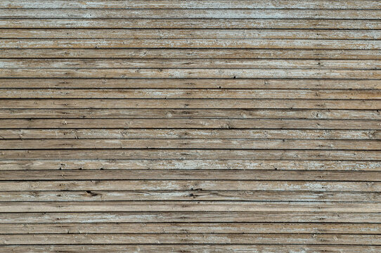 Weathered wooden wall with exfoliated light gray paint. Horizontal texture of old painted wood for wallpaper or background. Full frame image, empty template for design, copy space