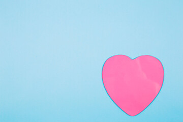 Pink heart on pastel blue background. Minimal Valentines day concept.