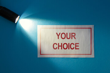 Inscription on a white card in the beam of light - Your choice
