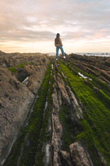 Young caucasian woman at the flysch geopark at the Basque Country.