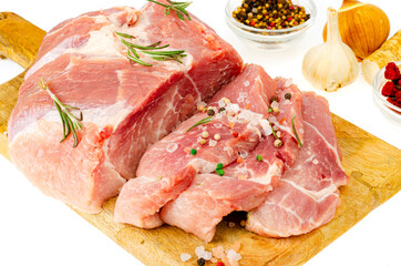 Piece of raw fresh pork with spices for cooking meat dishes. Studio Photo