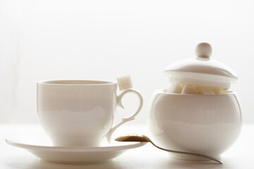 White sugar cube on cup of coffee. Smile. Concept.