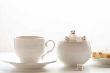 White sugar cube on cup of coffee. Smile. Concept.