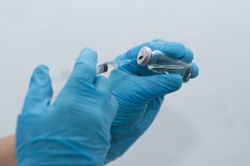 women's hands in medical gloves, vaccination