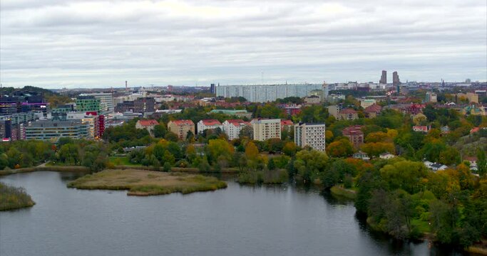 Flying over lake  with city suburb on the background, Sweden