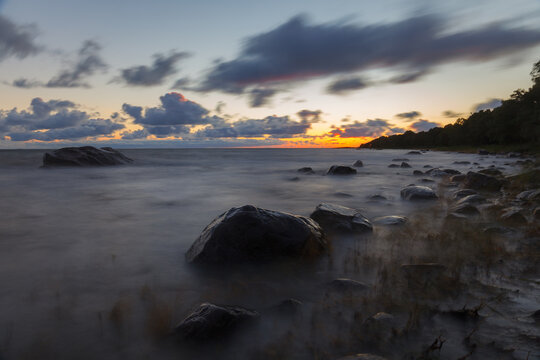 Baltic sea stones at sunset. Waves over shallow water. © yegorov_nick
