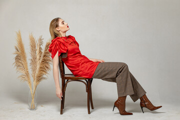 woman in dress sitting on chair