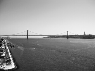 Aerial view at the Tagus River and the 25th of April Bridge. View from Discoveries Monument. Black and white concept.  Lisbon, Portugal