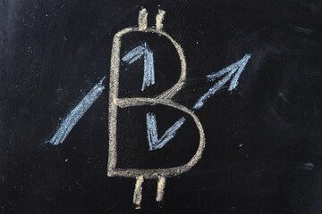 Chalk drawing on the bitcoin board and the arrow of the rate growth chart