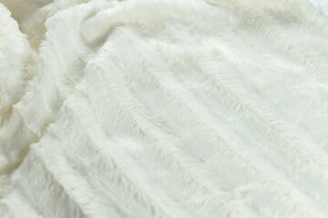 White fluffy fur furry plaid for bed, bedding texture, stripes pattern, wrinkled woven light material 