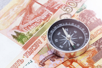 Compass and five thousand rubles bills