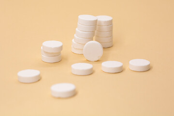A stack of pills on a beige background. Growth graph made of stacked white pills - growing market and increasing demand for white pill and it's substitutes.