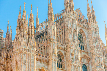 Famous church Milan Cathedral Duomo di Milano with Gothic spires and white marble statues. Top...