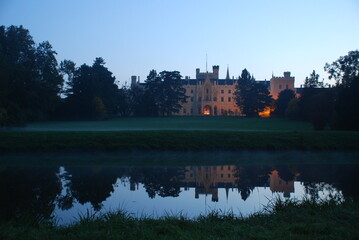 Naklejka premium Lednice Chateau reflected in water in evening
