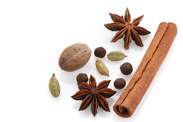 Spices for winter dishes, isolated on white background . Mulled wine or ingredients for seasonal Christmas baking are aromatic spices. Close-up