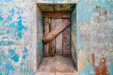 exit boarded up by boards in an old house