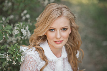 Fototapeta premium Large portrait of a beautiful girl in white flowers 2696.