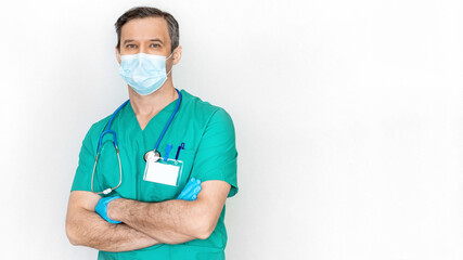 Friendly male doctor in disposable mask isolated on white background. Medical services banner concept. Mockup with a badge on the doctor's pocket. Coronavirus treatment concept.