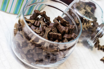 Dog treats spilling out of bowl. Dog treats and biscuits