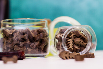Dog treats spilling out of bowl. Dog treats and biscuits