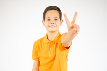 Young little boy victory gesture standing over isolate background
