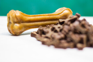 Dog bone for chewing on a green background