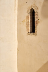 A vintage window in the wall of an old house.