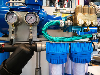 Equipment of an industrial enterprise. Blue compressor, pressure gauges and pipes. Packaging...