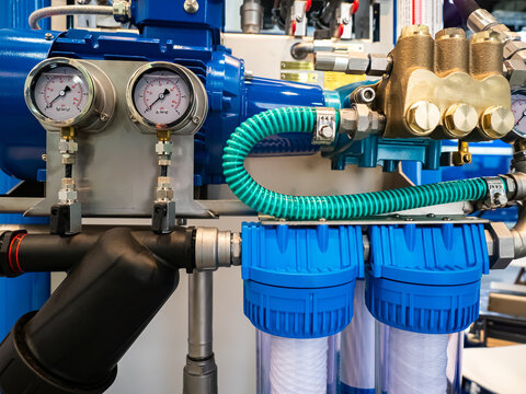 Equipment of an industrial enterprise. Blue compressor, pressure gauges and pipes. Packaging production. Production equipment. Machines in the shop.