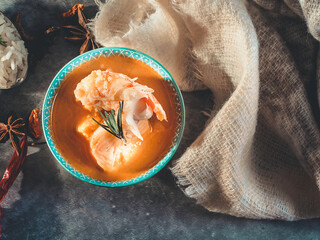 TOP VIEW OF A FISH SOUP ACCOMPANIED BY A HANDKERCHIEF