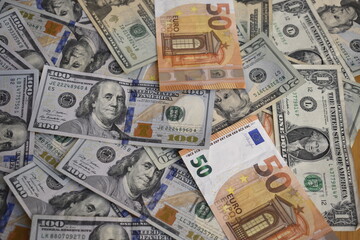 Fototapeta na wymiar dollar and euro bills in disarray 