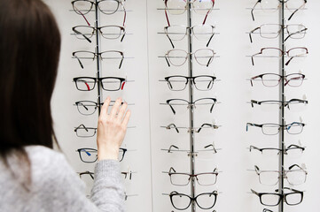 Row of glasses at an opticians. Eyeglasses shop. Stand with glasses in the store of optics.