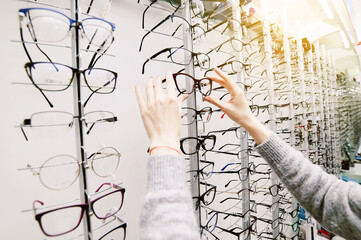 Row of glasses at an opticians. Eyeglasses shop. Stand with glasses in the store of optics.