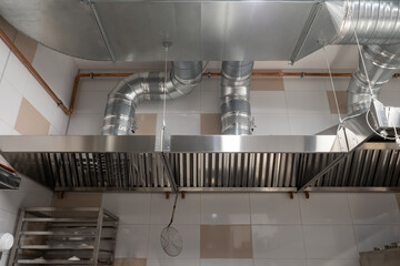 Ventilation in the industrial kitchen. Stainless steel ventilation pipe system. Air ducts in the...