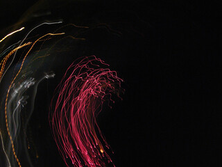 Abstract neon lights of fireworks on the sky.