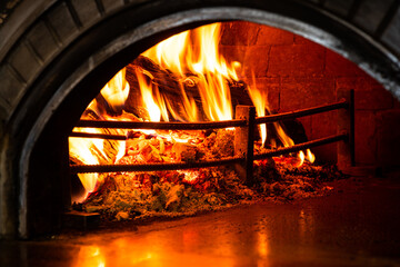 Hot Flames in Pizza Oven. Traditional Firewood Stone Wood Fired Pizza Oven