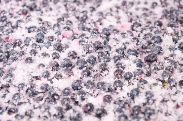 Blueberry berries peppered with sugar background close-up