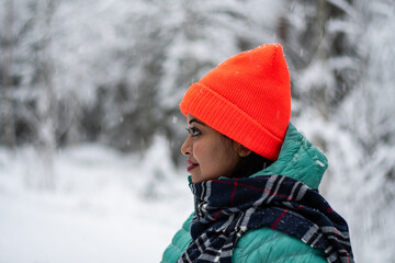 An asian beautiful model woman in a winter wonderland enjoying the snow wearing colourful cloths