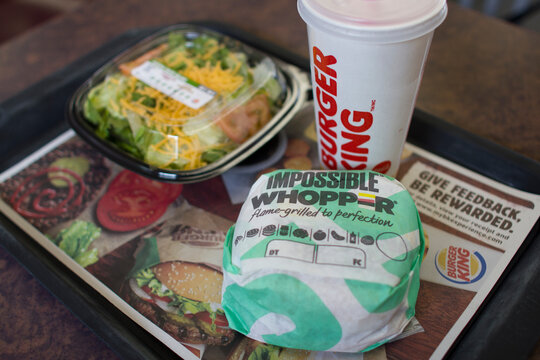 Portland, Oregon, USA - Aug 30, 2019: An Impossible Whopper Sandwich And A Side Garden Salad In A Burger King Restaurant In Portland. The Sandwich Is Made With An Impossible Brand Plant-based Patty.