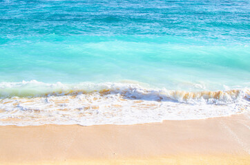 Waves and sand mixing on the beach