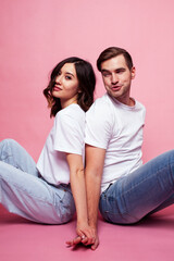 young cheerful caucasian couple together having fun on pink background, guy ang girl modern relationship, lifestyle people concept