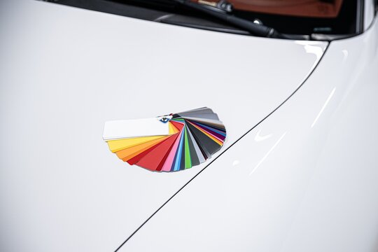 Man choosing color of his car with color sampler. Car foil wrapping colors picker
